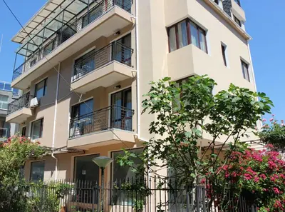 an apartment building with balconies and flowers at Flowers Apartments in Nesebar