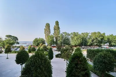 a garden with trees and bushes in a park at Varna South Bay - Monk Apartment in Varna City