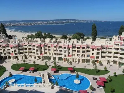 an aerial view of a resort with two pools and chairs at Varna South Bay - Monk Apartment in Varna City