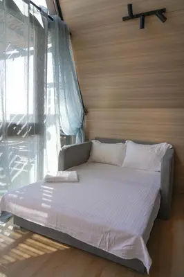 a bed in a room with a large window at Elysium Lozenets in Lozenets