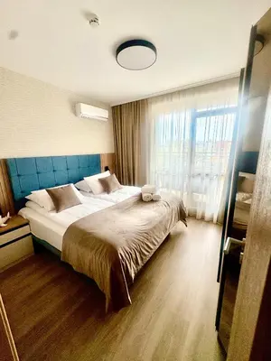 a bedroom with a large bed and a large window at Sorrento E 4 4 Sveti Vlas in Sveti Vlas