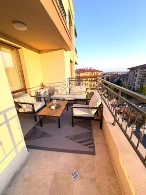a balcony with couches and tables on a building at Sorrento E 4 4 Sveti Vlas in Sveti Vlas