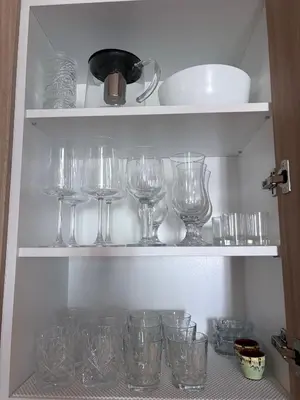 a bunch of wine glasses sitting on shelves at Sorrento E 4 4 Sveti Vlas in Sveti Vlas
