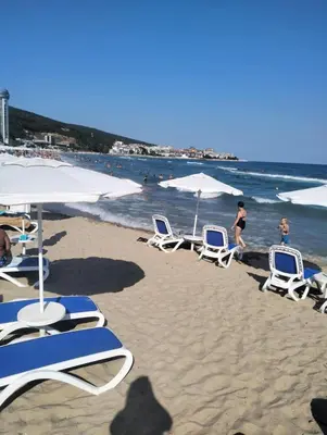 a group of chairs and umbrellas on a beach at Grand rezort Marína Beach in Sveti Vlas