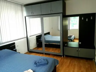 a bedroom with a mirror and a bed in it at Apartment Stoyanovi in Primorsko