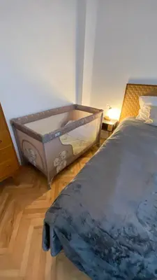 an empty bed in a room with a bed sidx sidx sidx at Downtown Central point Varna Apartment in Varna City