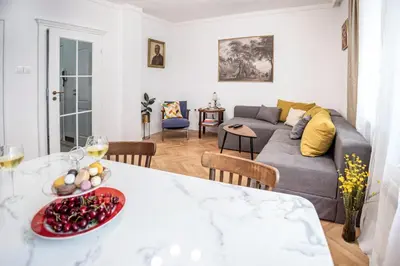 a living room with a table and a couch at Downtown Central point Varna Apartment in Varna City