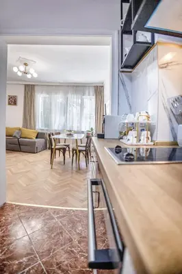 a kitchen and living room with a table and chairs at Downtown Central point Varna Apartment in Varna City