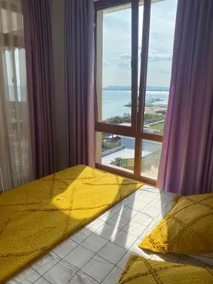 a bedroom with a bed and a large window at Tryavna Beach Violet 42 in Sveti Vlas