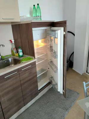 an empty refrigerator with its door open in a kitchen at 2 Room Apartment Costa Calma Aheloy Bulgarien in Aheloy