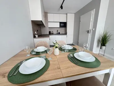 a dining room table with plates and glasses on it at Valentina Apartment in Burgas City