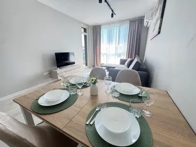 a dining room table with plates and wine glasses at Valentina Apartment in Burgas City