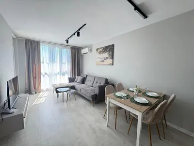 a living room with a table and a couch at Valentina Apartment in Burgas City