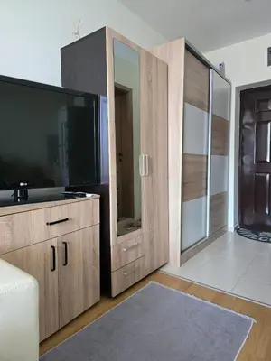 a living room with a large flat screen tv at Orchid Fort Garden in Sunny Beach