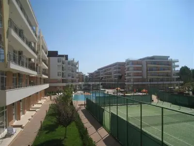 a tennis court in front of some apartment buildings at Grand Кameliq - MORSKI BRIZ apartment in Sunny Beach