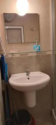 a bathroom with a white sink and a mirror at Grand Кameliq - MORSKI BRIZ apartment in Sunny Beach
