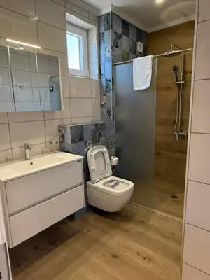 a bathroom with a toilet and a sink and a shower at Aurum Villas Smokinya Beach 2 in Sozopol