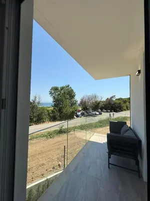 a living room with a couch and a view of a road at Aurum Villas Smokinya Beach 2 in Sozopol