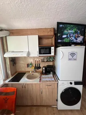 a small kitchen with a sink and a microwave at Studio Vili 2 in Varna City