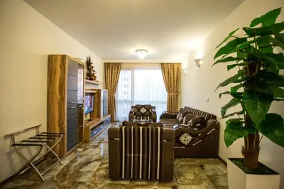 a living room with a radiator and a couch at Boutique Apart Hotel Versis in Sunny Beach