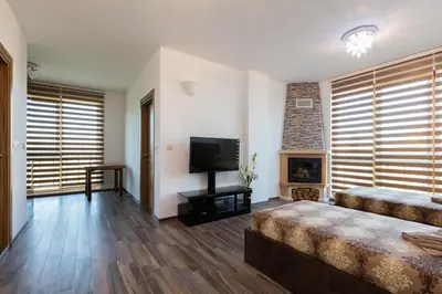 a large living room with a television and a fireplace at Boutique Apart Hotel Versis in Sunny Beach