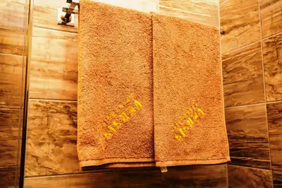 a towel hanging on a wall in a bathroom at Boutique Apart Hotel Versis in Sunny Beach