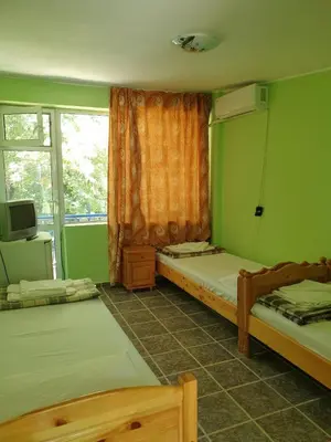 a room with two beds and a window at Hotel Maria in Kiten