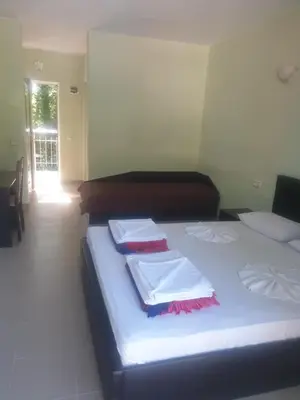 a bedroom with two beds with towels on them at Hotel Maria in Kiten