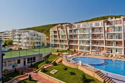 a large apartment building with a pool and a tennis court at Sunset Complex Кошарица Апартамент 15 in Kosharitsa