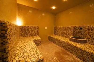 a room with two benches in a room with tiles at Sunset Complex Кошарица Апартамент 15 in Kosharitsa