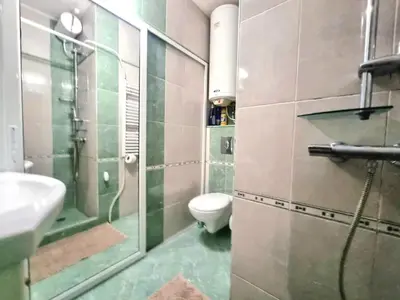 a bathroom with a toilet and a sink and a shower at Aquapark 2BD Apartment for Family in Sunny Beach