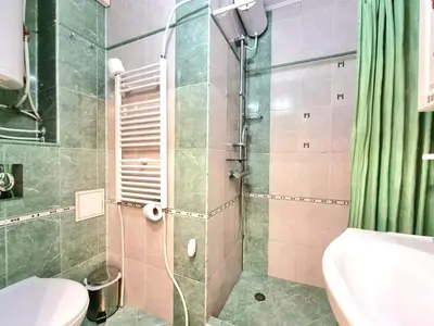 a bathroom with a shower with a toilet and a sink at Aquapark 2BD Apartment for Family in Sunny Beach