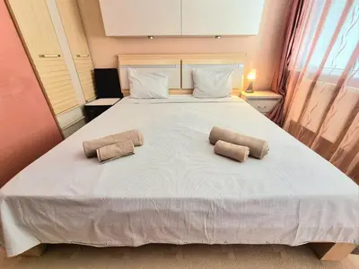 a bedroom with a large bed with two pillows on it at Aquapark 2BD Apartment for Family in Sunny Beach