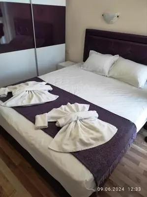 a bed with two towels on top of it at Blue Beach Apartments - Amara in Ravda