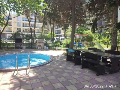 a swimming pool with a table and a piano at Blue Beach Apartments - Amara in Ravda