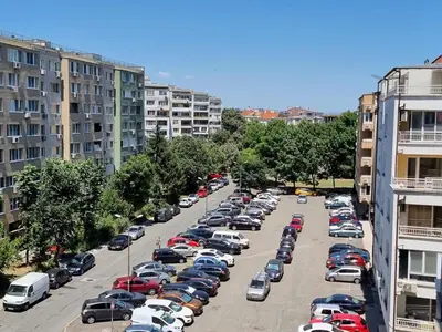 a parking lot full of cars in a city at Sunrise Dreams Apartment with free Parking in Burgas City
