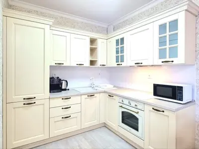 a white kitchen with white cabinets and a microwave at Sunrise Dreams Apartment with free Parking in Burgas City