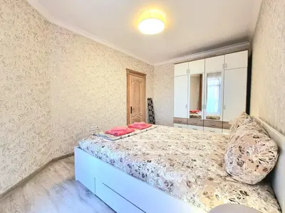 a bedroom with a large bed with pink pillows at Sunrise Dreams Apartment with free Parking in Burgas City