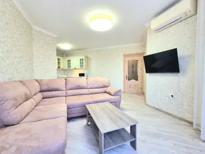 a living room with a couch and a table at Sunrise Dreams Apartment with free Parking in Burgas City