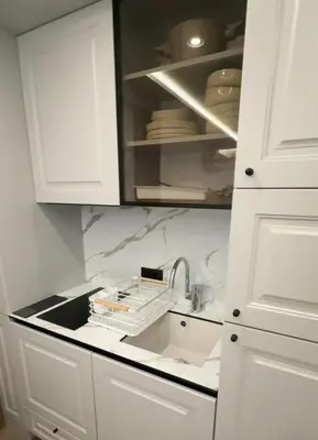a kitchen with white cabinets and a sink at Sea Home 8 in Sunny Beach