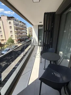 a balcony with two chairs and a table on a building at Sea Home 8 in Sunny Beach