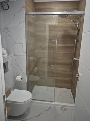a bathroom with a glass shower with a toilet at Verano Deluxe Studios in Burgas City