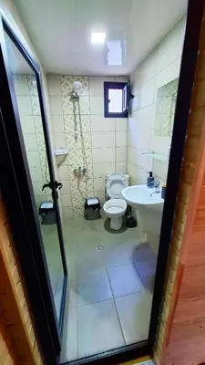 a bathroom with a toilet and a sink at Еко Къщи Градина in Sozopol