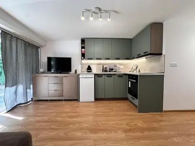 a kitchen with green cabinets and white appliances at Studio Briz in Burgas City