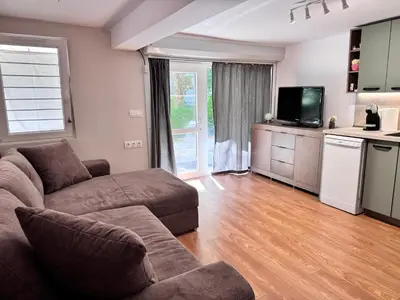 a living room with a couch and a tv at Studio Briz in Burgas City