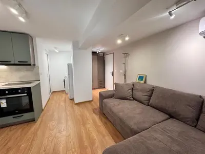 a living room with a couch and a kitchen at Studio Briz in Burgas City