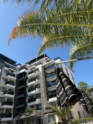 a traffic light in front of a building with a palm tree at Sea Home 9 in Sunny Beach
