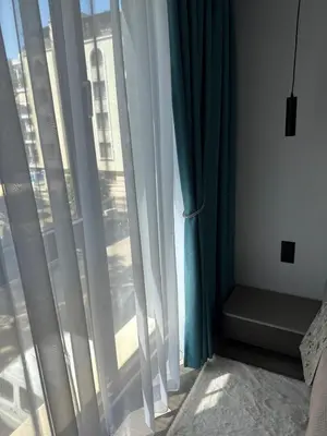a bedroom with a window with white curtains at Sea Home 9 in Sunny Beach