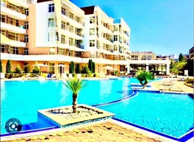 a large swimming pool in front of a building at Apartcomplex Grand Kamelia Sunny Beach in Sunny Beach