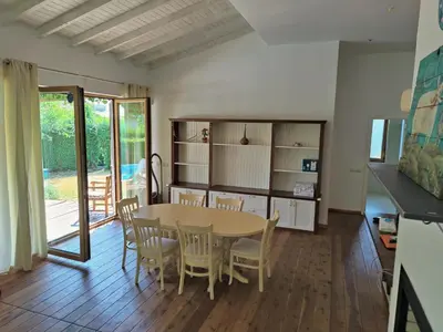 a kitchen and dining room with a table and chairs at Villa Casablanca with private pool in Lozenets